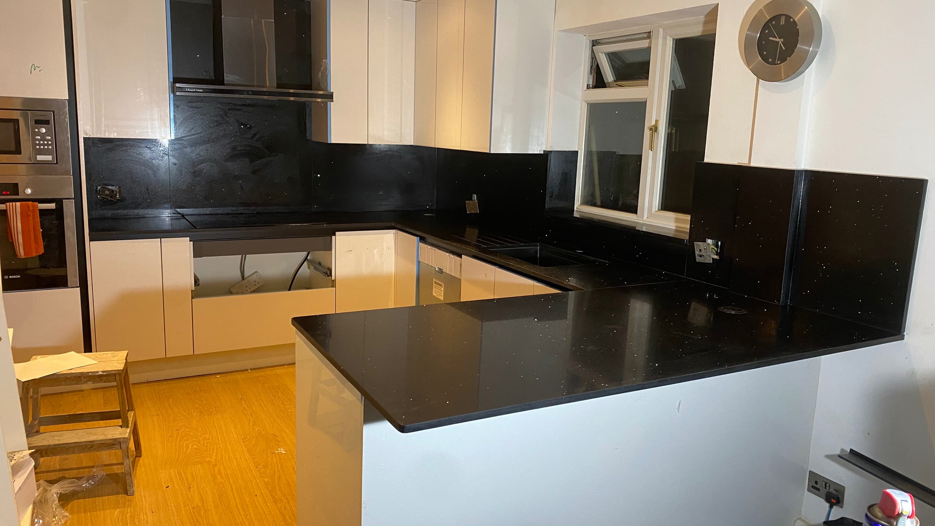 Black quartz worktops in a contemporary East Sheen kitchen