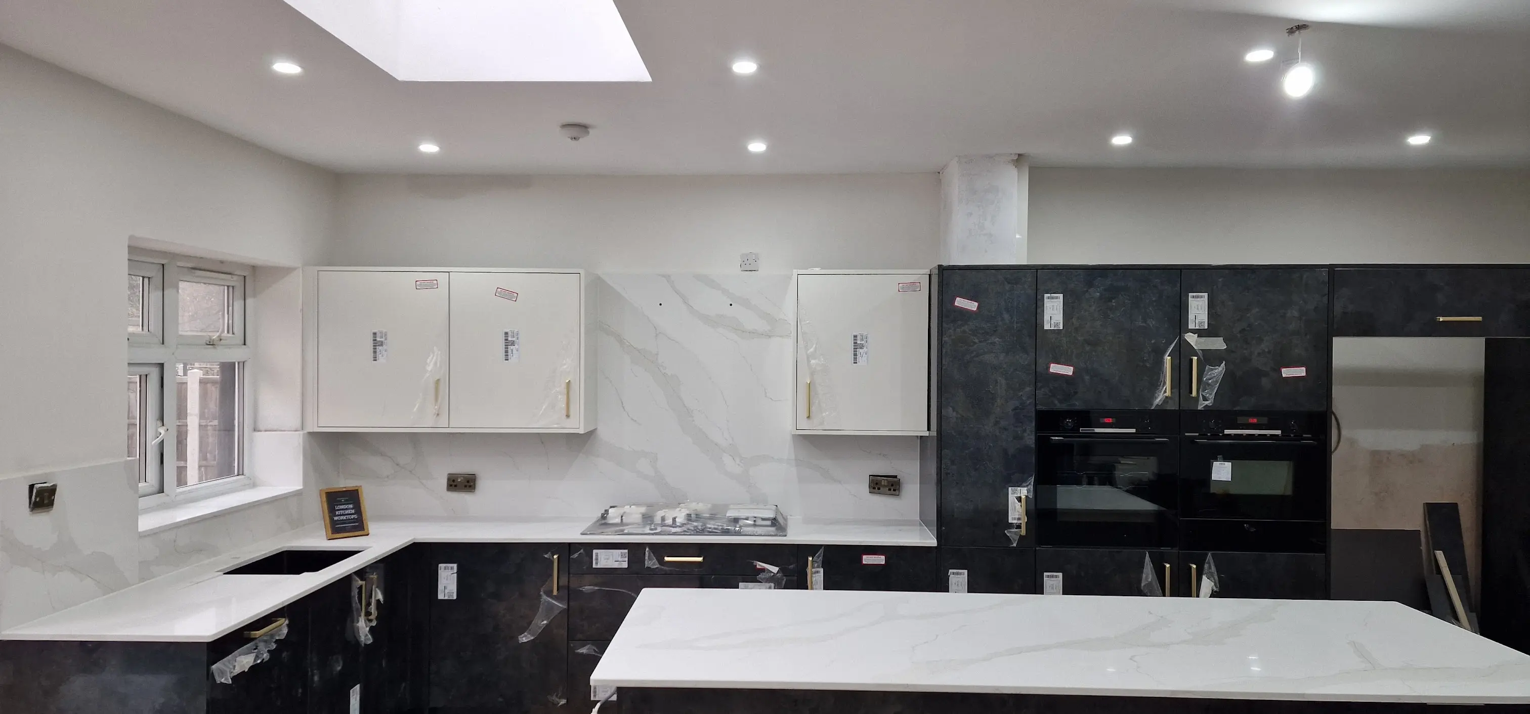 Calacatta quartz island in a Purley open-plan home with waterfall end