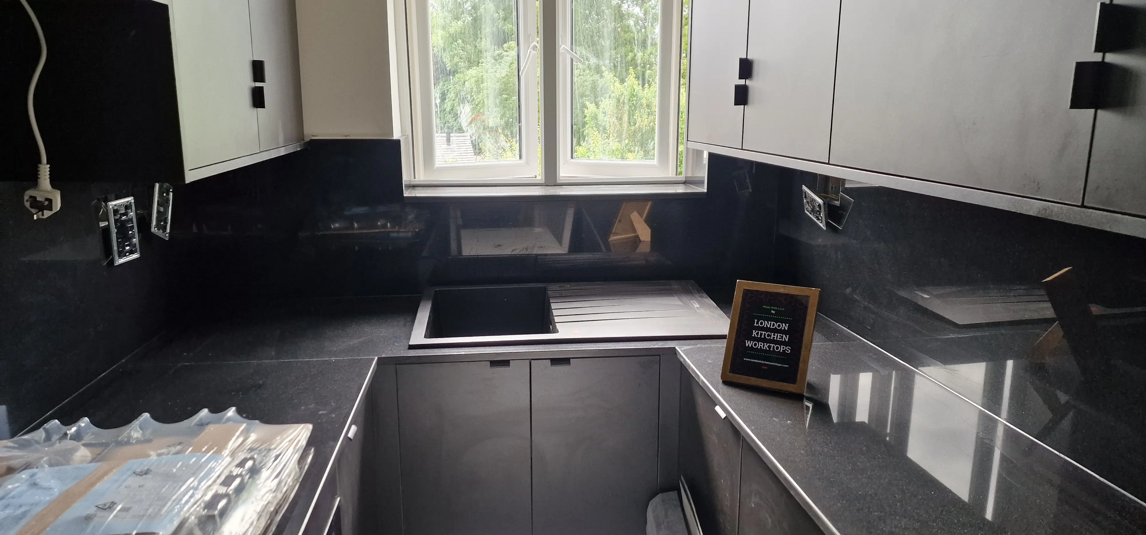 Polished black granite worktops in a period kitchen near Ealing
