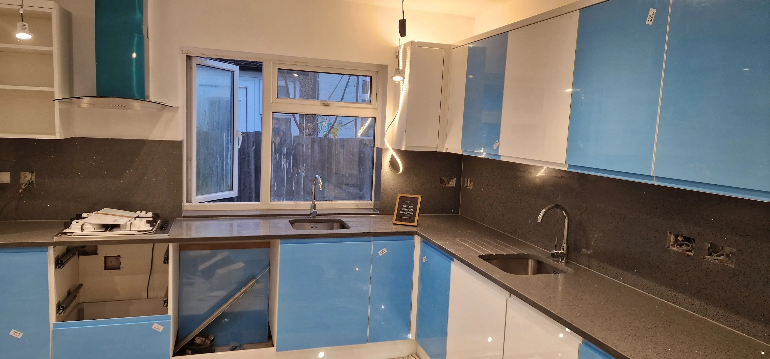 Grey quartz worktops fitted in a Northolt family kitchen
