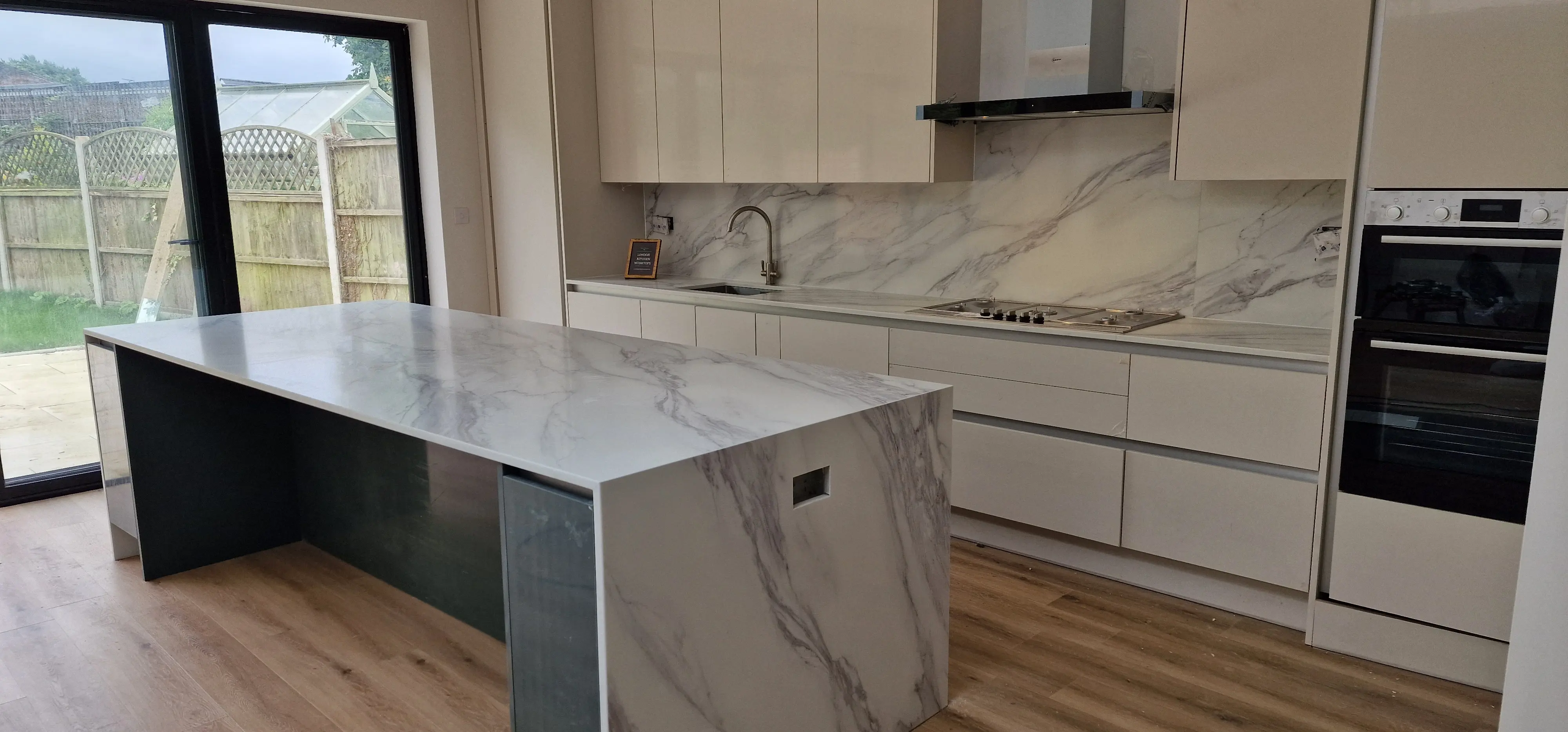 Quartz kitchen island with waterfall end installed in Greenford