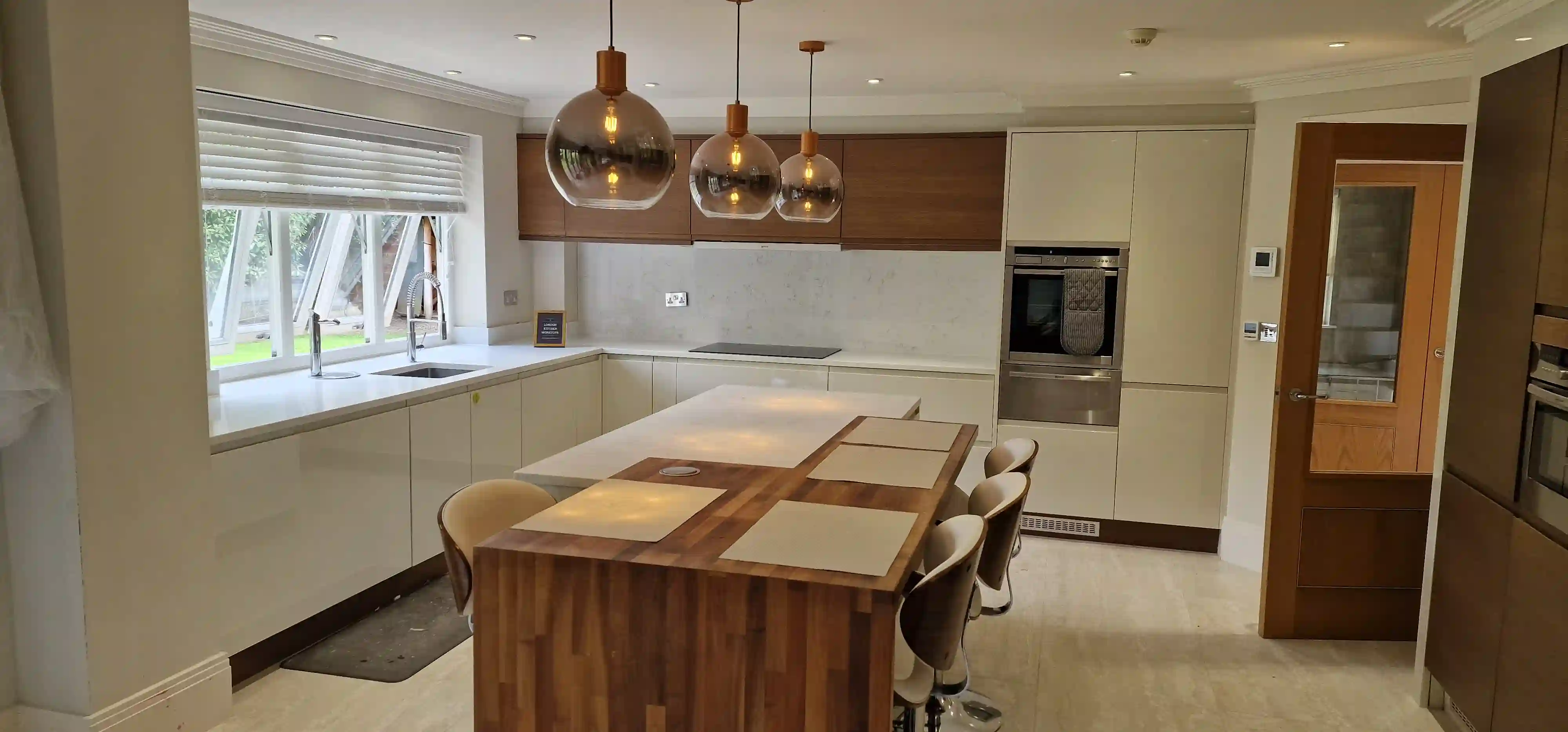 Matching quartz splashback and upstand with quartz worktops in East Sheen