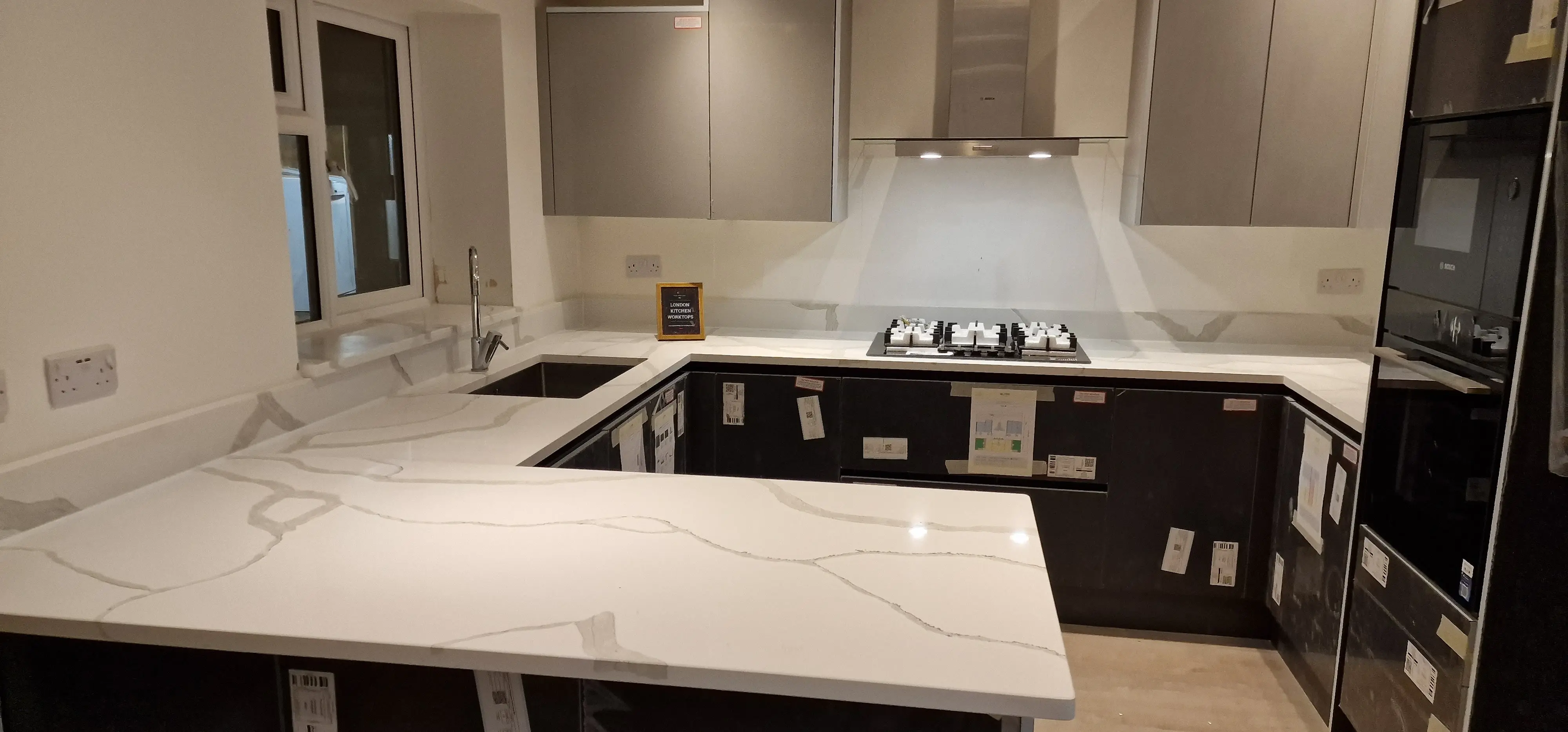 Matching quartz splashback and upstands in a finished Hampton quartz installation