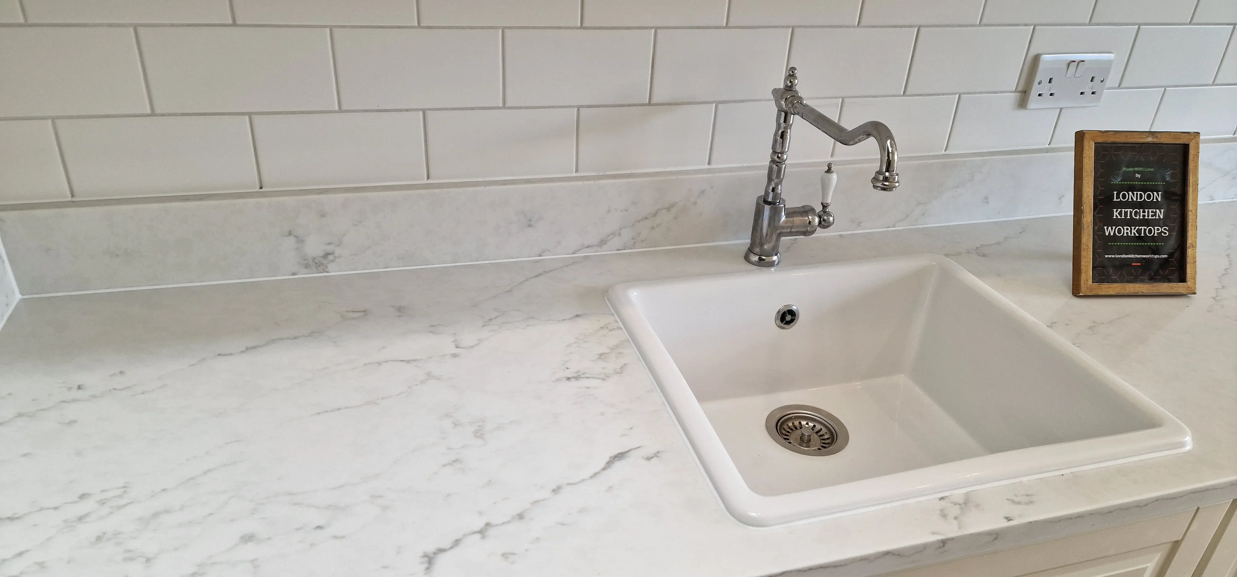 Matching quartz splashback and upstand in a Raynes Park kitchen