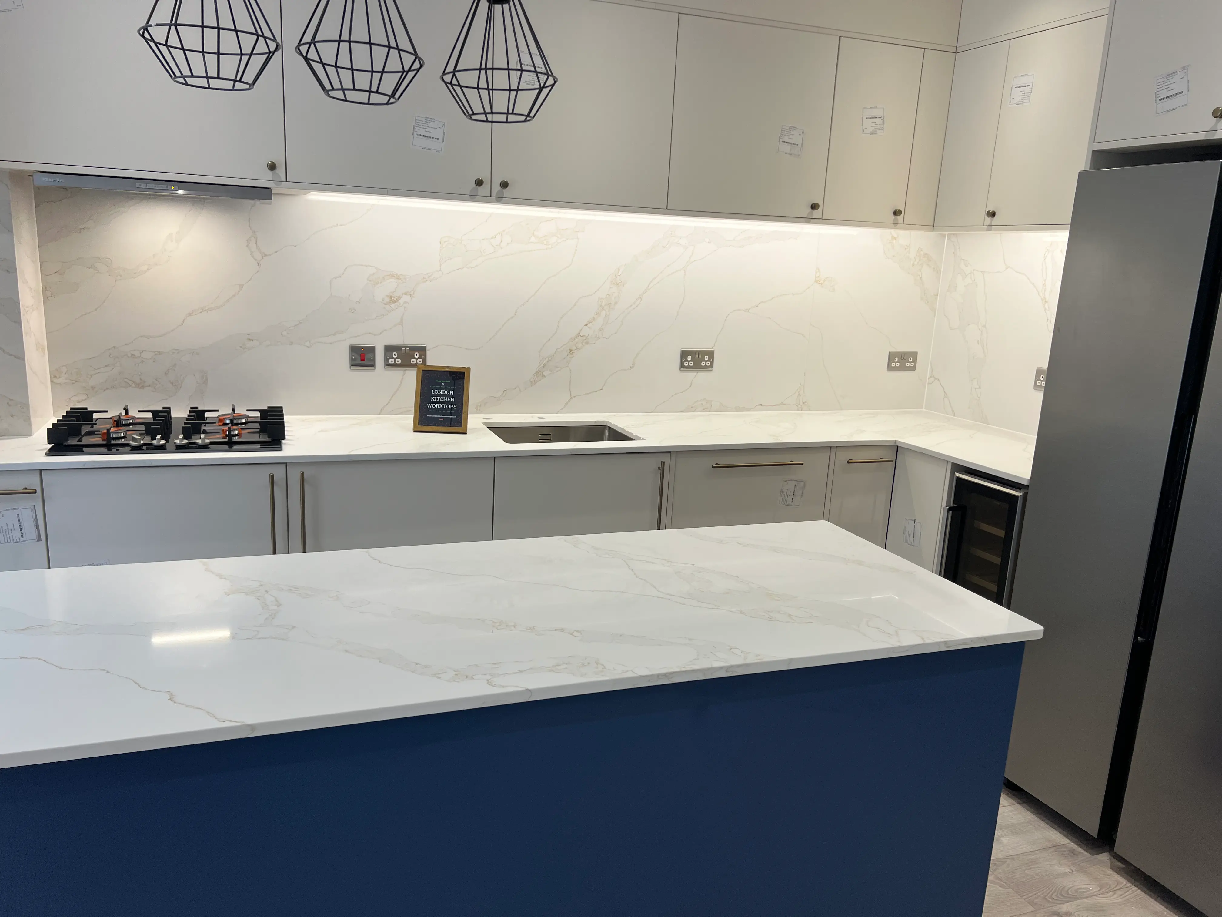 White Quartz Worktops Barnes White quartz worktops in a shaker-style kitchen for a Barnes home