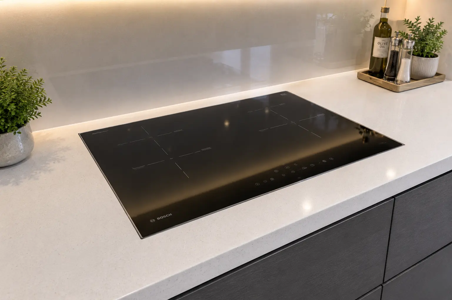 Quartz splashback and worktop behind hob in a Beckenham kitchen