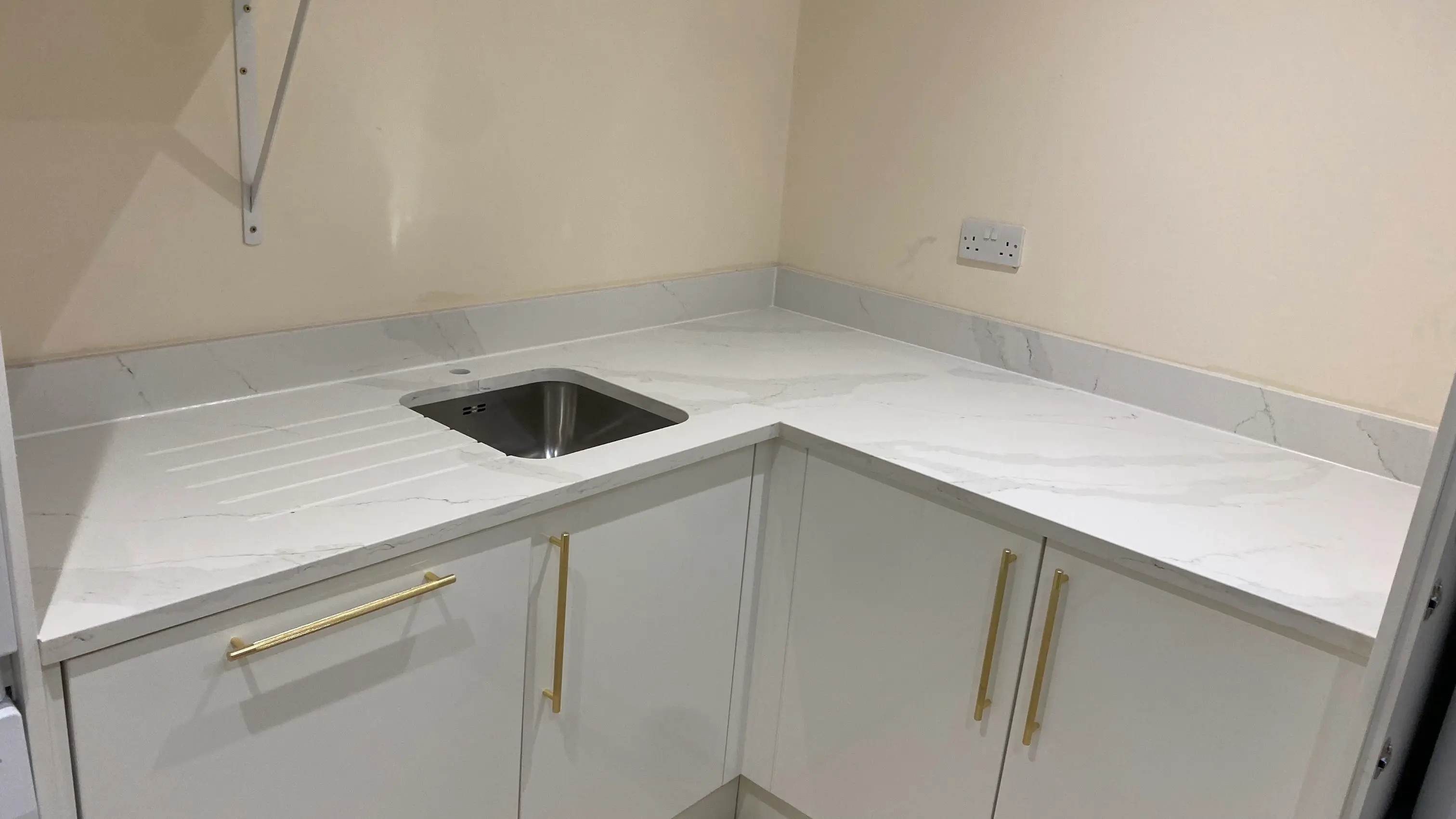 Quartz worktops fitted in a Bracknell utility room with matching surfaces