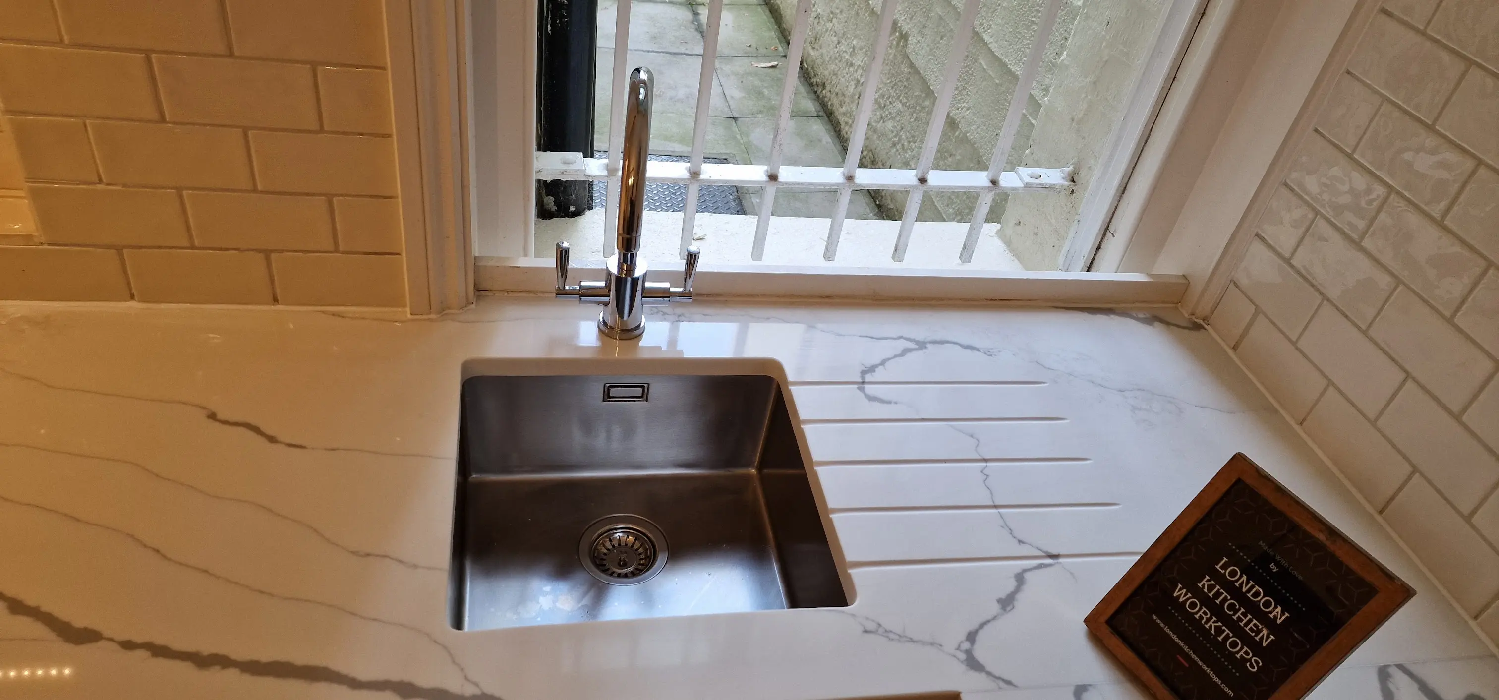 Quartz worktop with undermount sink cut-out in a Dorking kitchen.