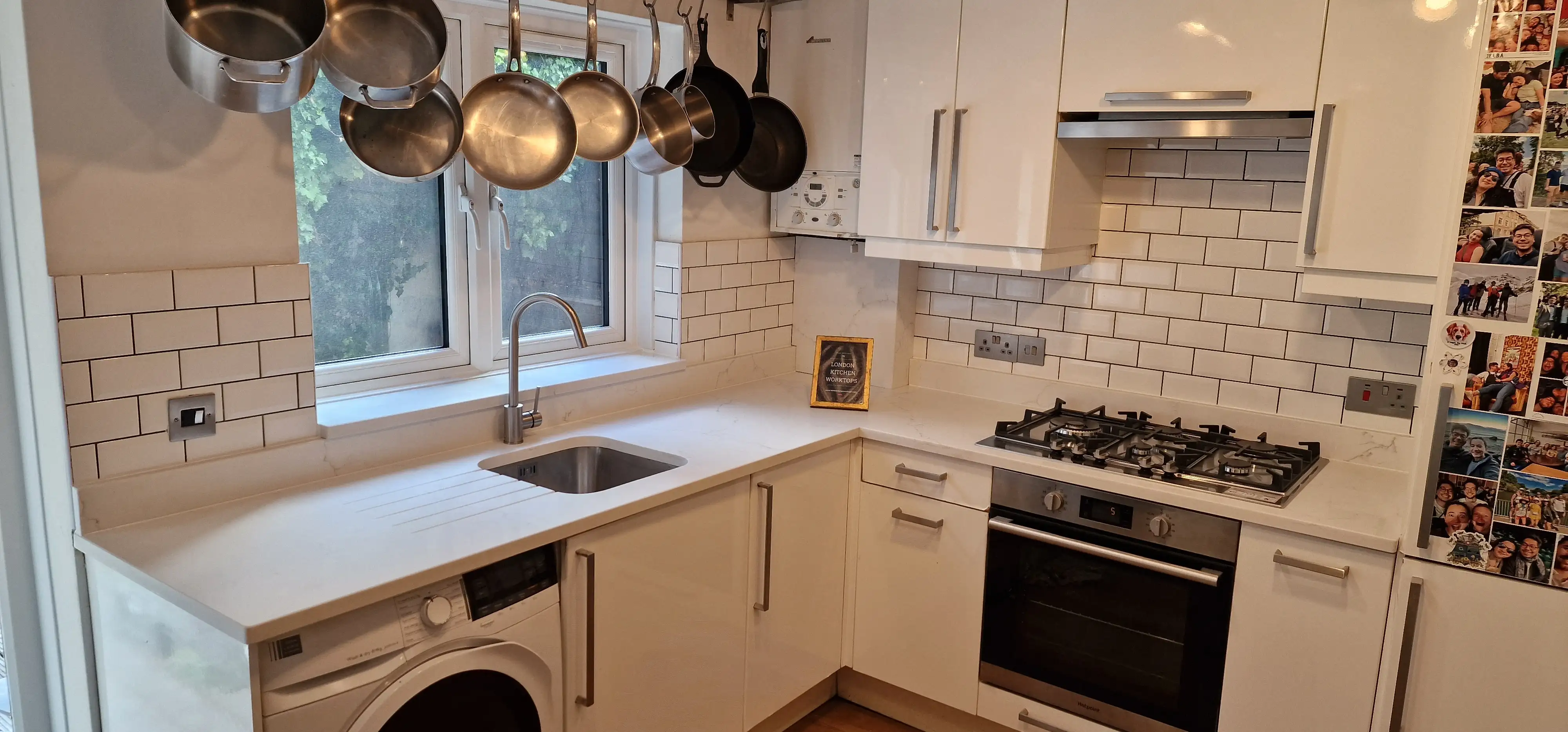 L-shaped quartz worktops with matching upstands in a Farnham home