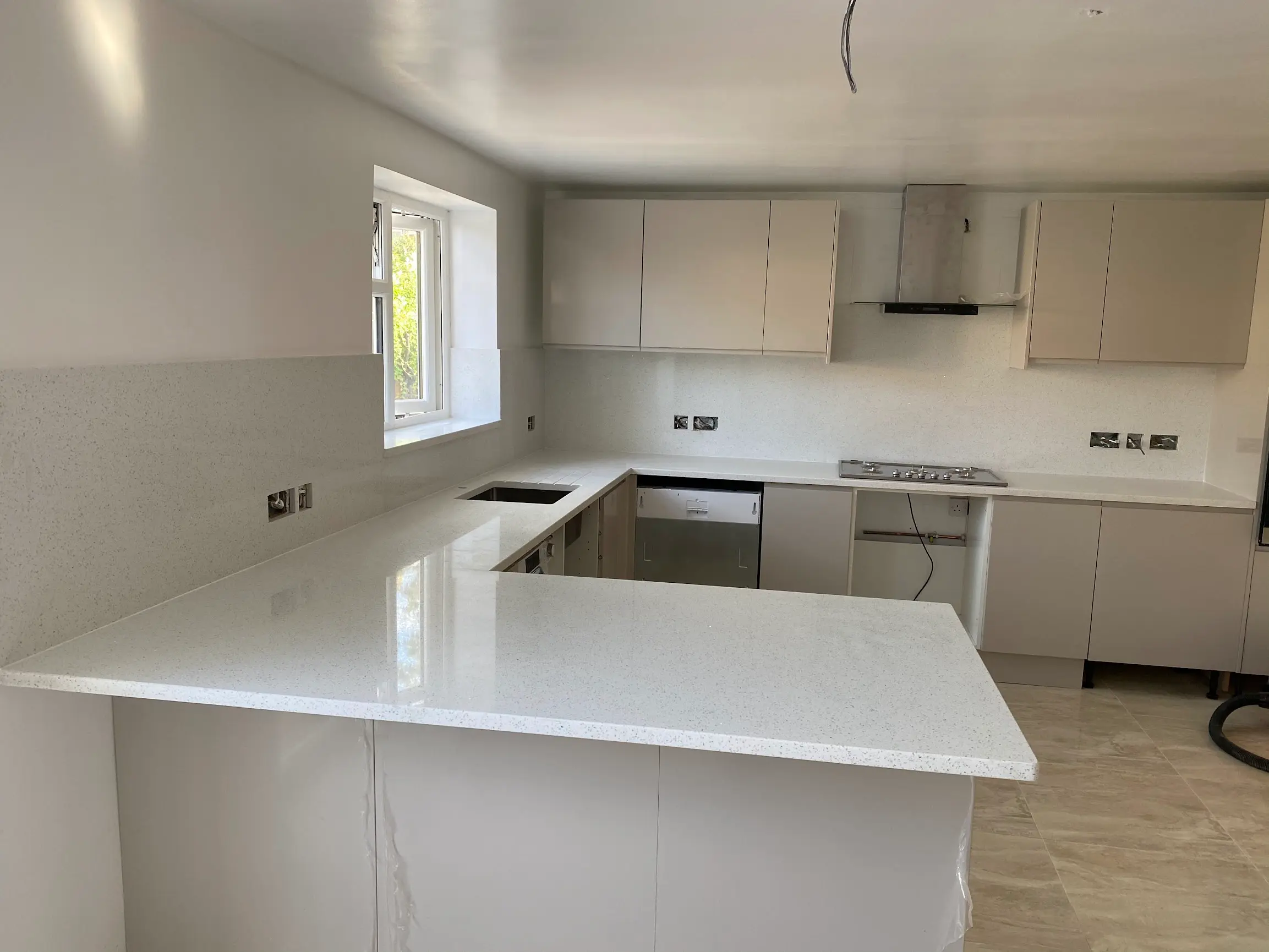 White quartz worktops fitted in a Greenford family kitchen