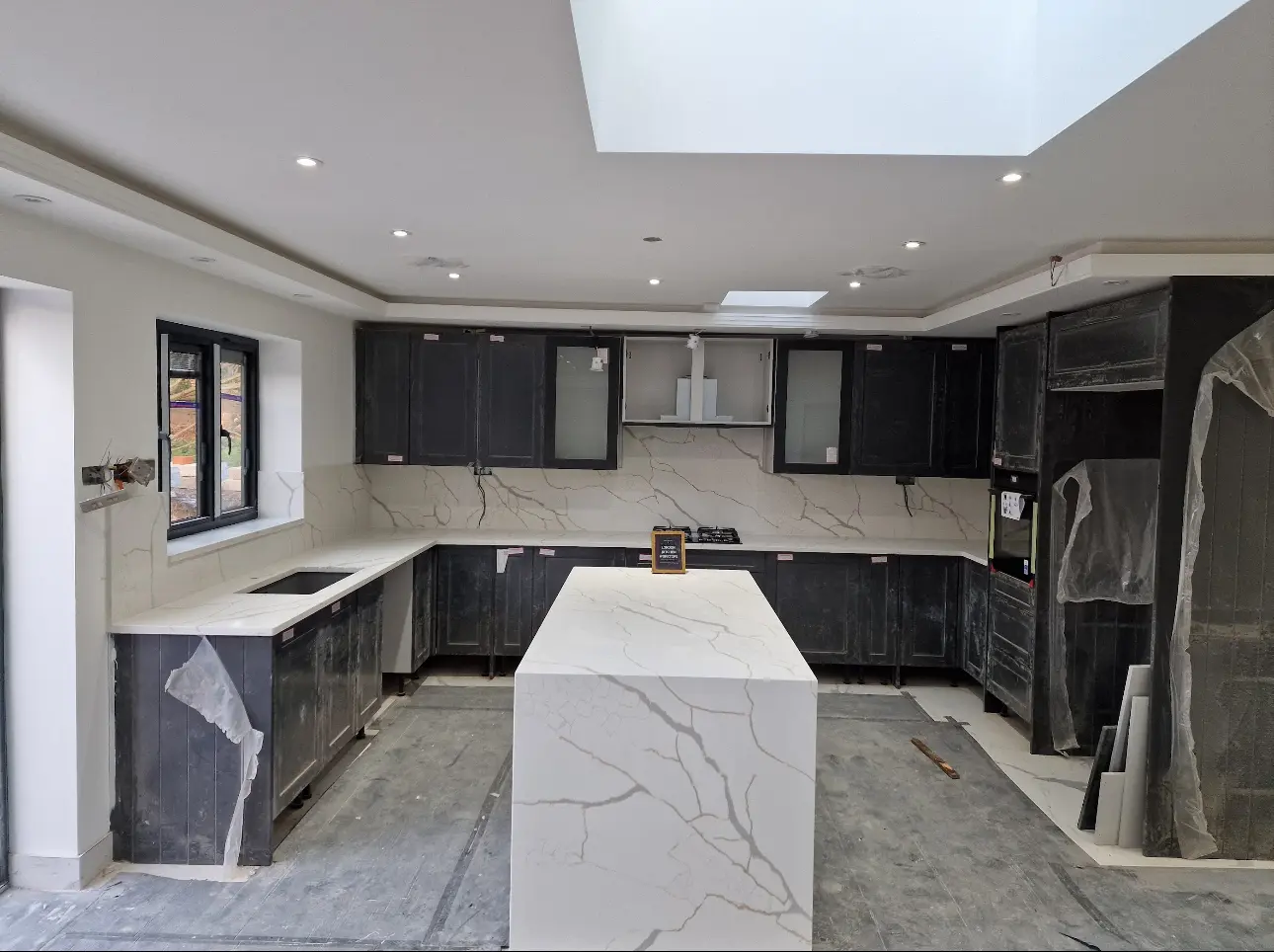 Harrow Quartz Waterfall Island Quartz waterfall island end panel installed in a Harrow home
