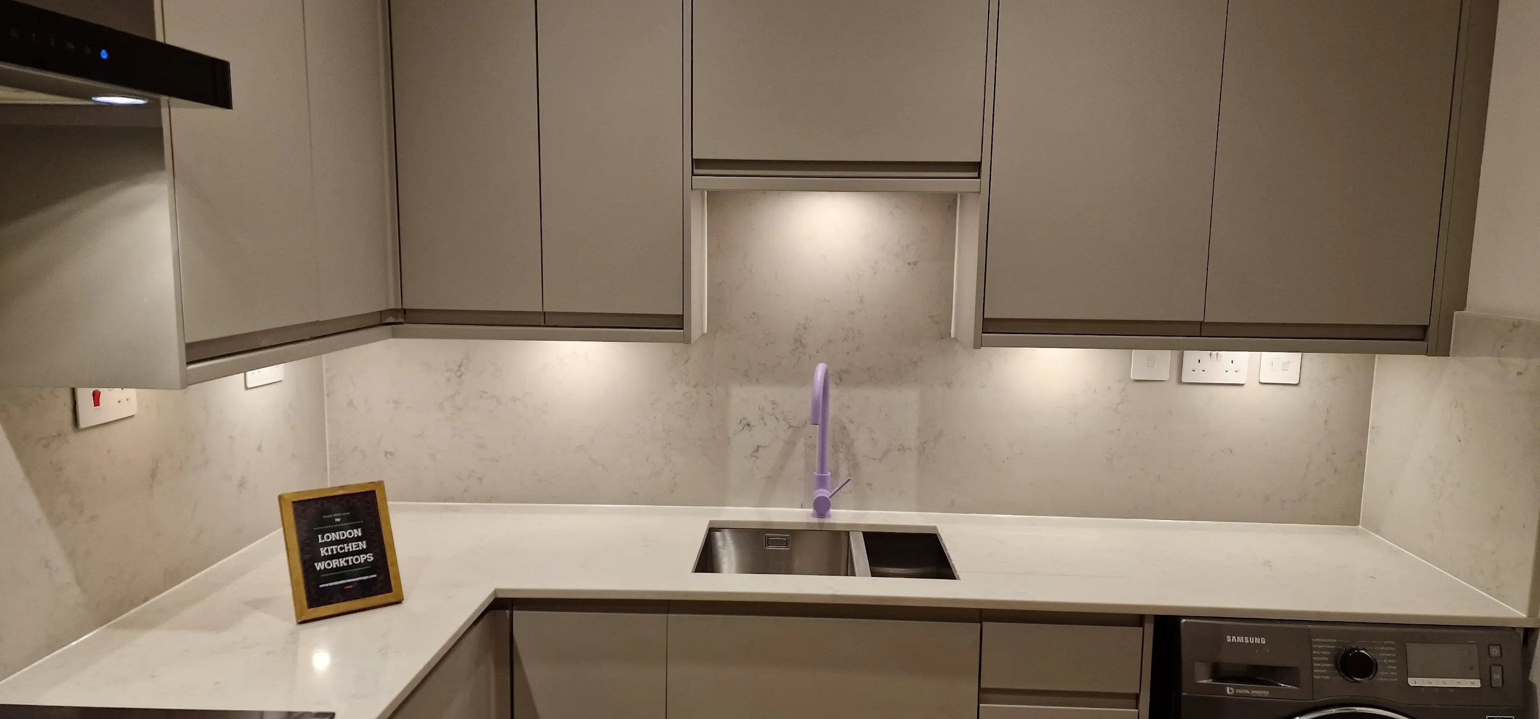 White quartz worktop with clean polished finish in a bright kitchen