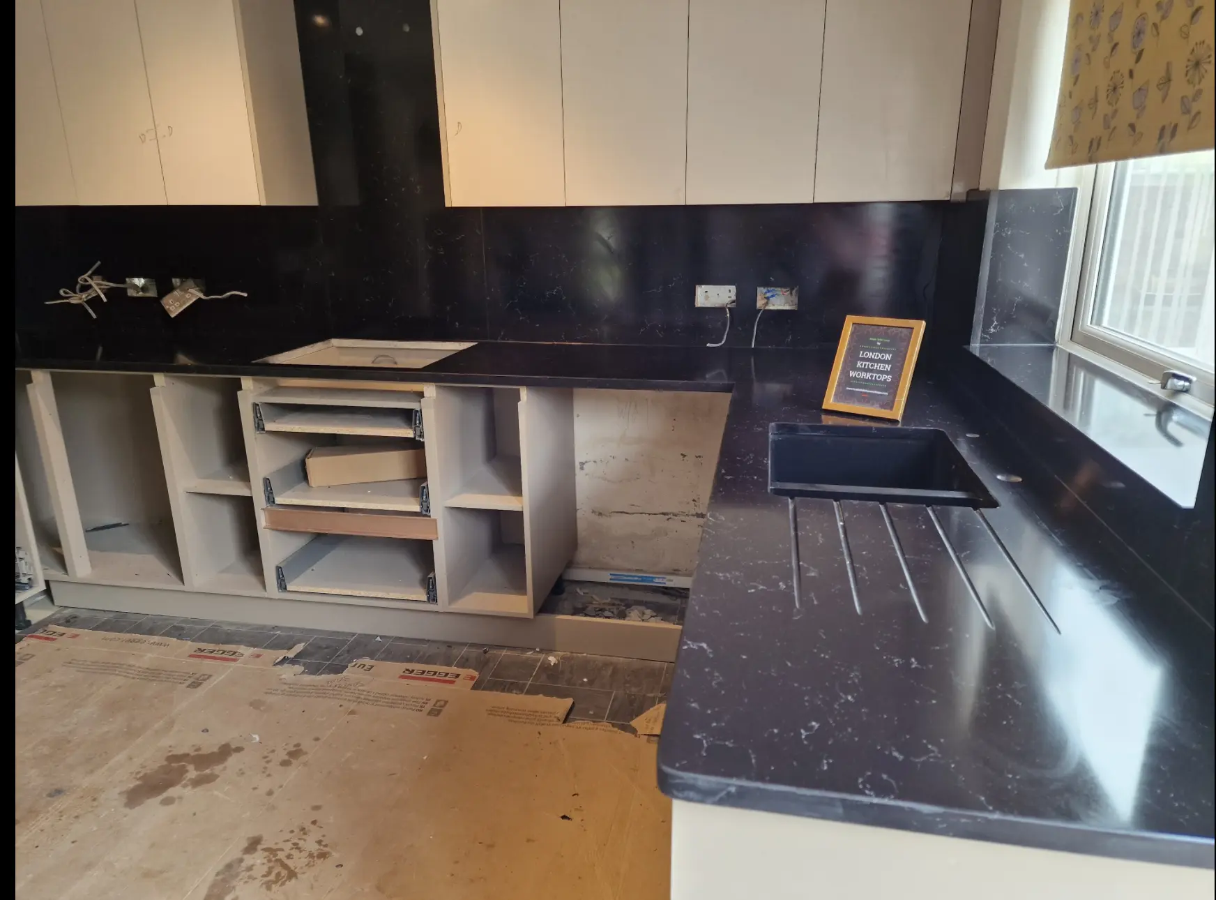 Black quartz worktops Isleworth Black quartz worktops with a polished finish in an Isleworth kitchen