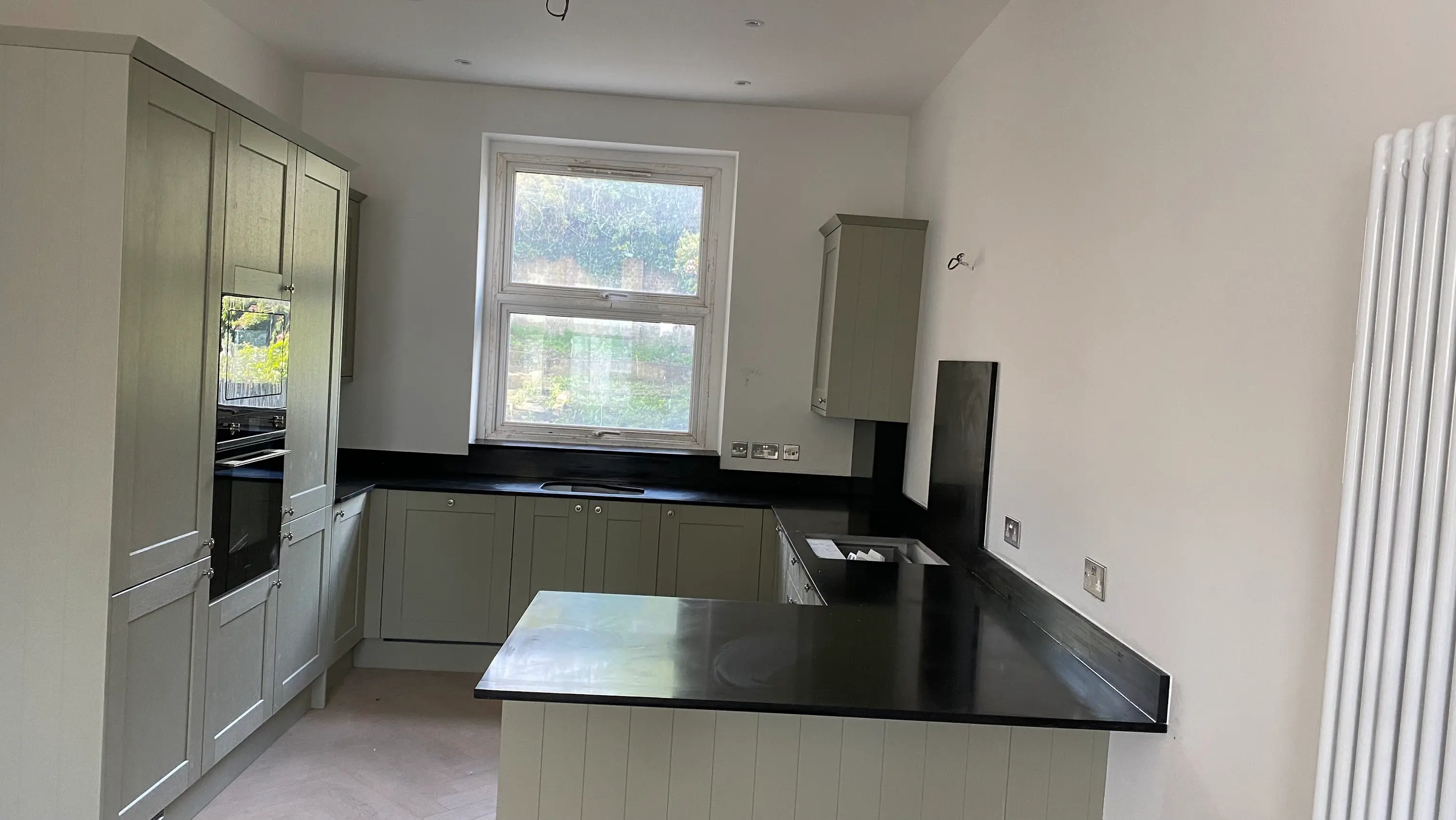 Black Quartz Worktops Perivale Black quartz worktop with contrasting cabinets in Perivale