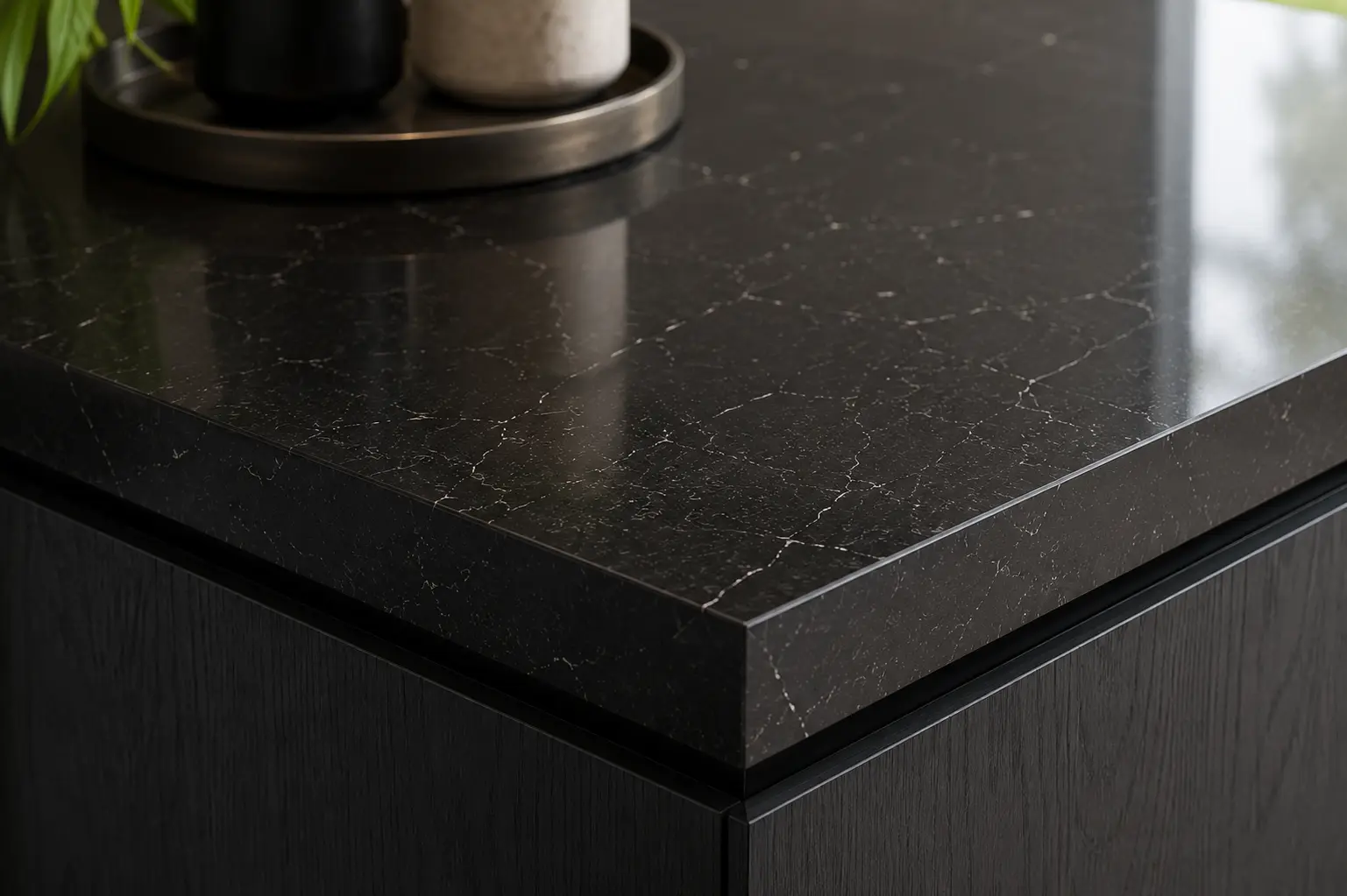 Black quartz island worktop with polished edge detail in Twickenham