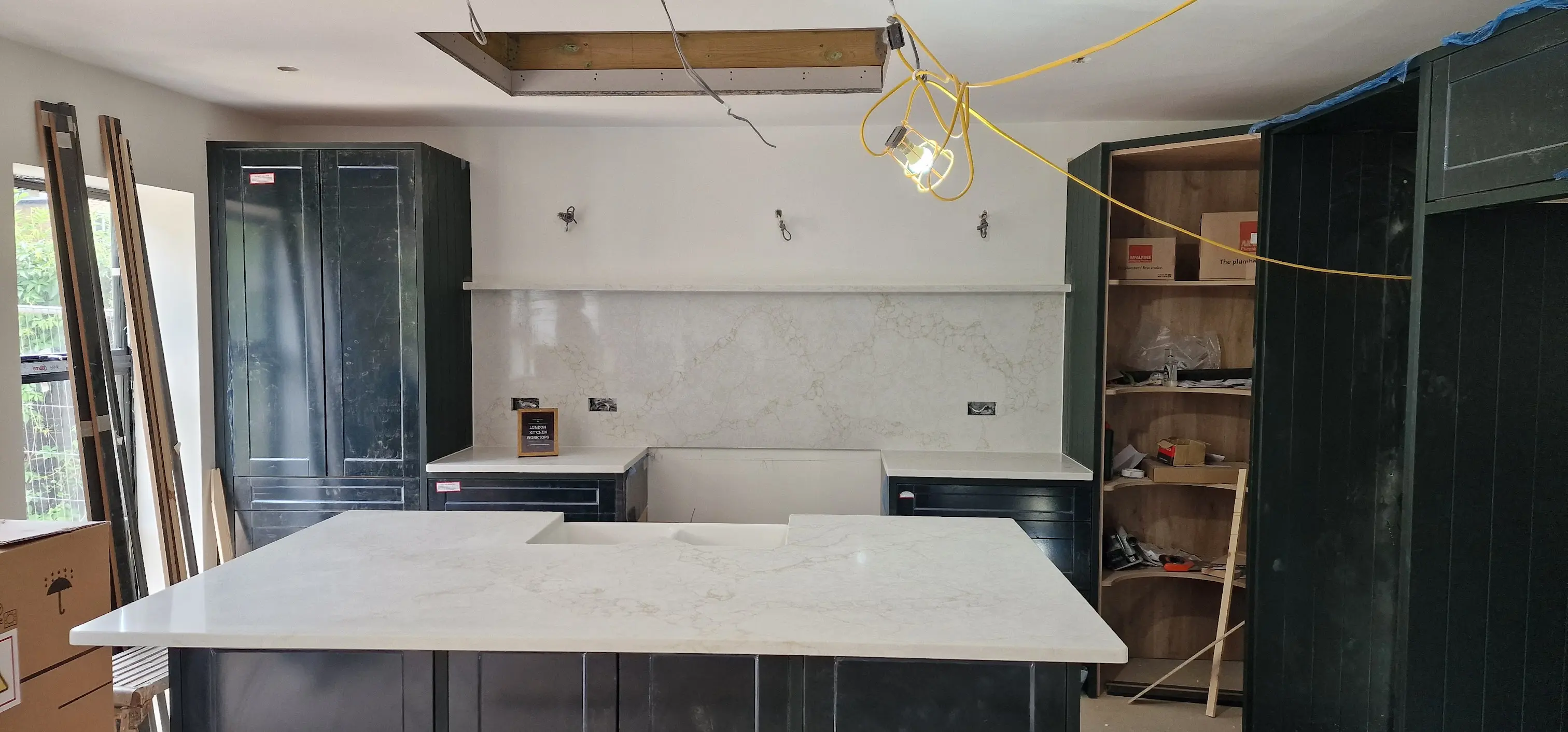 White quartz worktops with matching splashback in Hammersmith