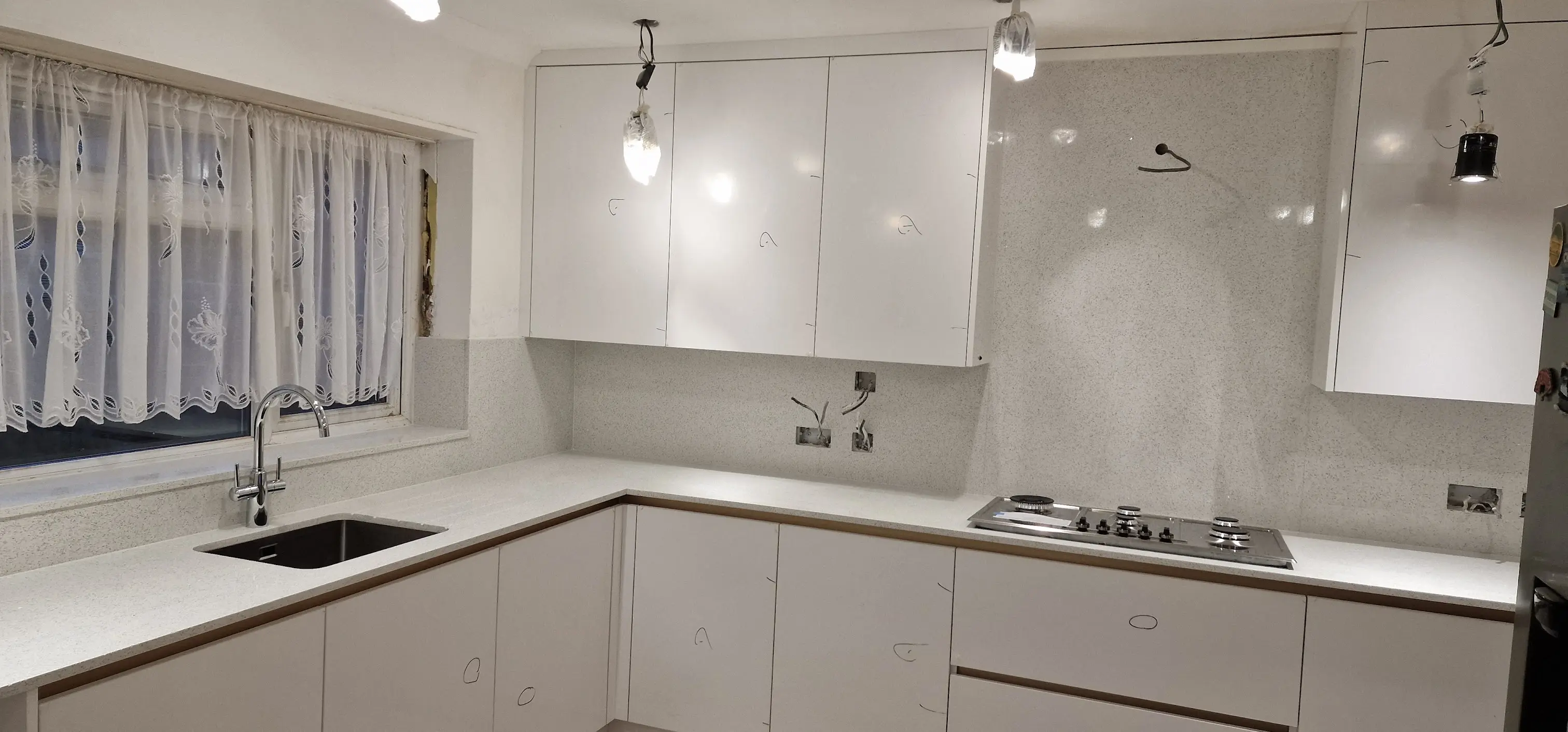 White Quartz Worktops Harrow Flat White quartz worktops in a Harrow flat kitchen with compact layout