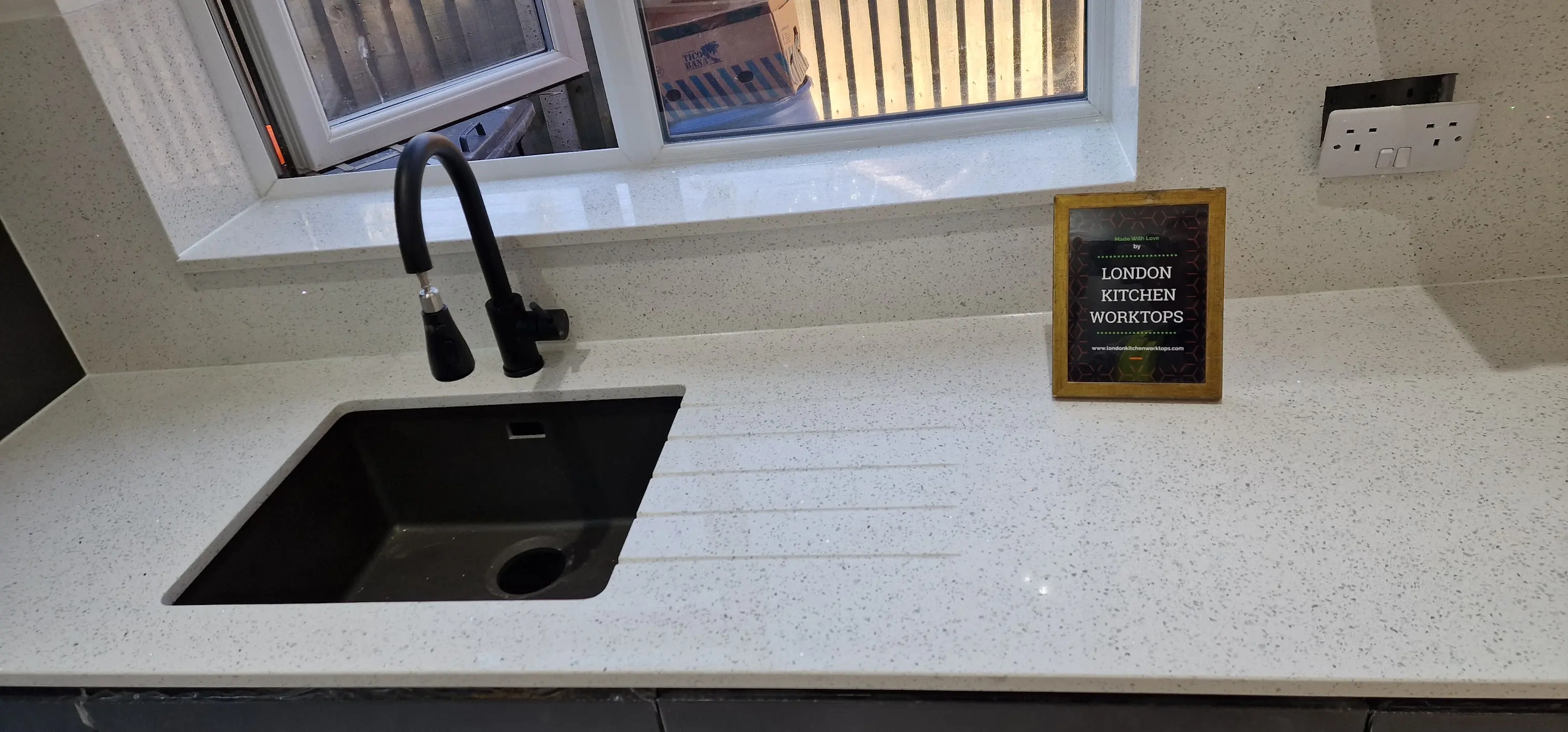 Bright white quartz worktop in a compact Purley kitchen with clean edge detail